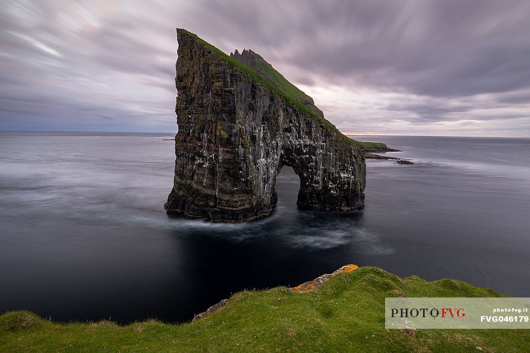 Drangarnir is the collective name of two sea stacks, which are called Stri Drangur (large rock) and Ltli Drangur (small rock) respectively, and are located next to each other between the islands of Vgar and Tindhlmur, Srvgsfjrur Fjord near Srvgur, Faeroe islands, Denmark